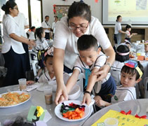 蔬果服務員翁宇正小朋友把食物端給客人們享用。【攝影：尤靜蓓（慮忱）】